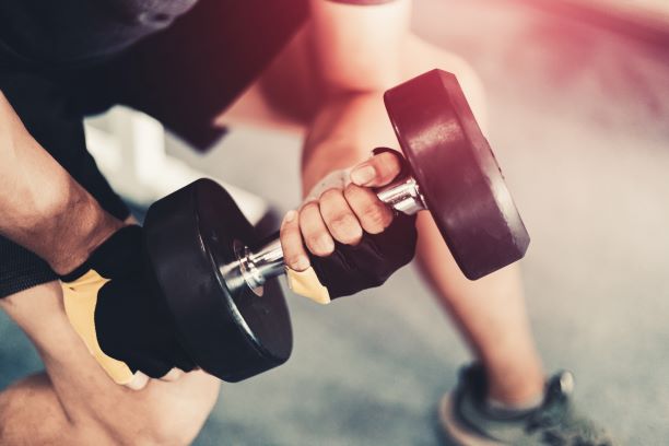 Man performing bicep curl holding dumbell