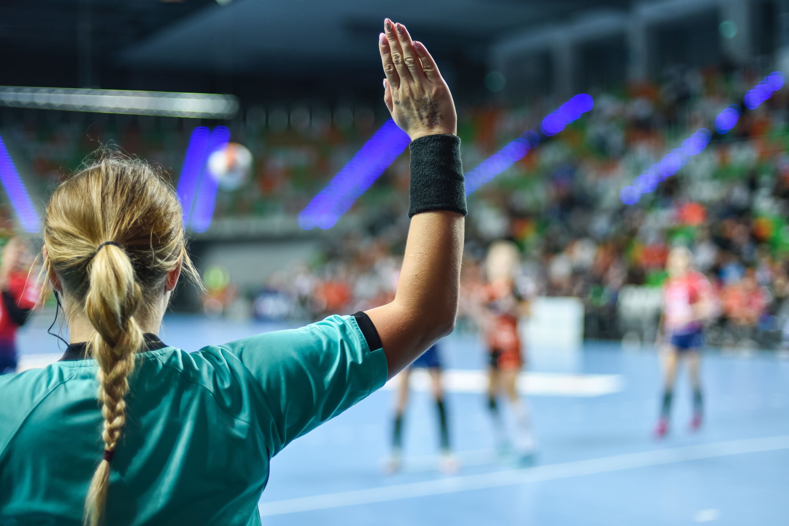 Female referee making a call during a volleyball game