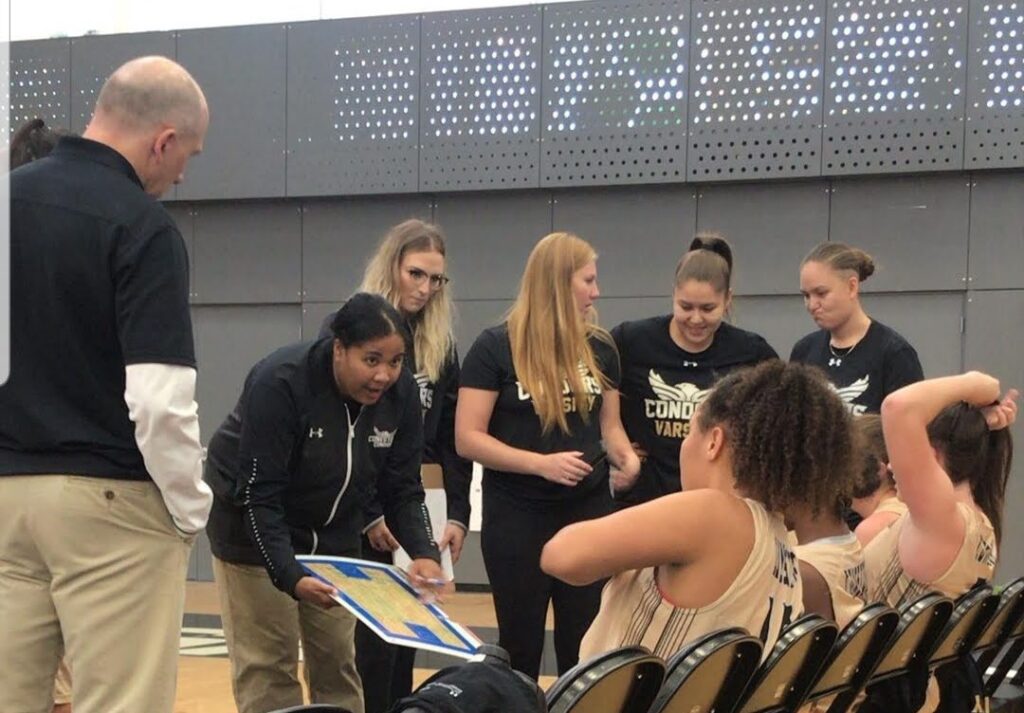 Woman coach giving instruction to her team